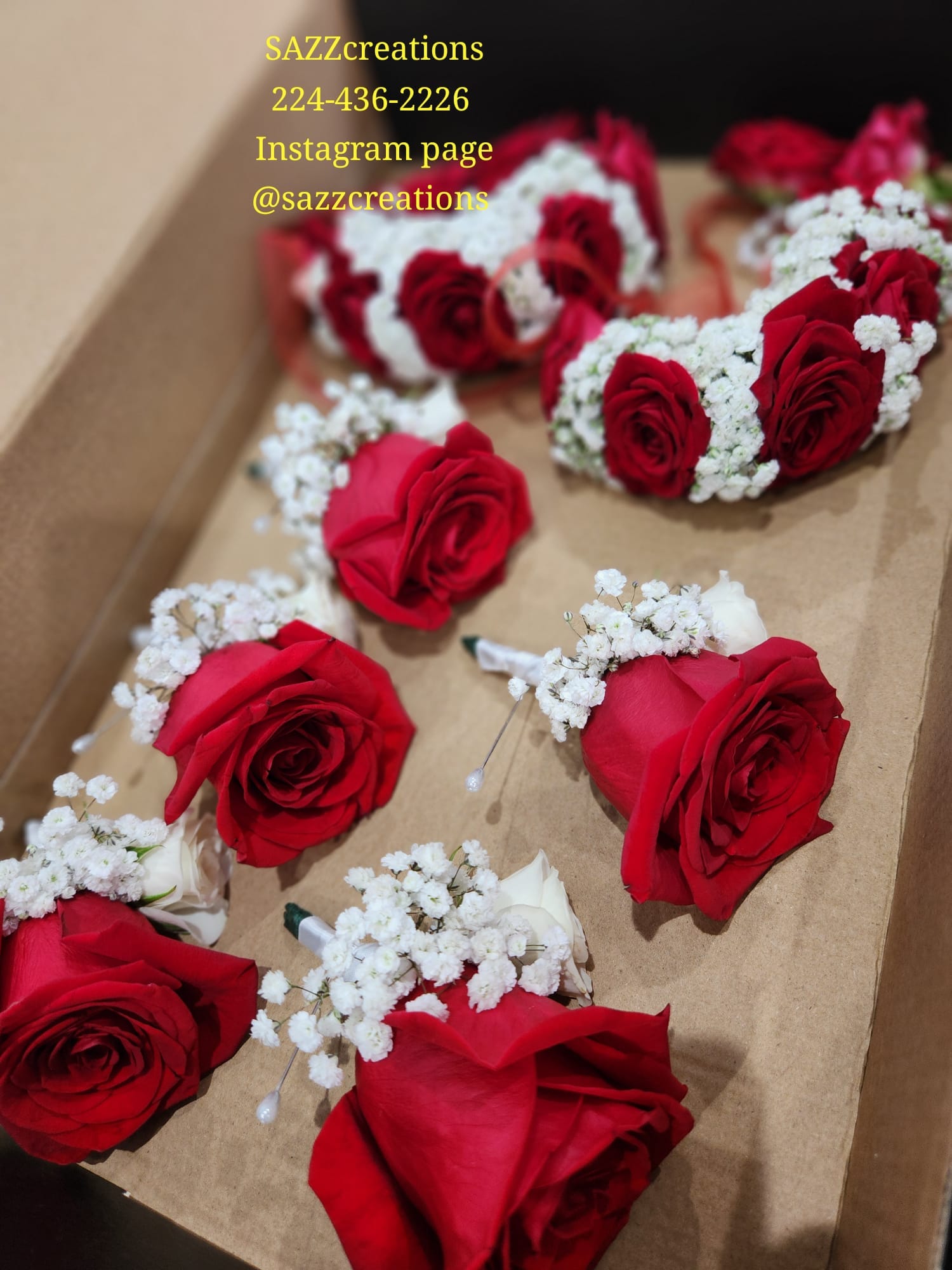 Red rose and white rose boutonnieres with baby's breath arranged in a gift box