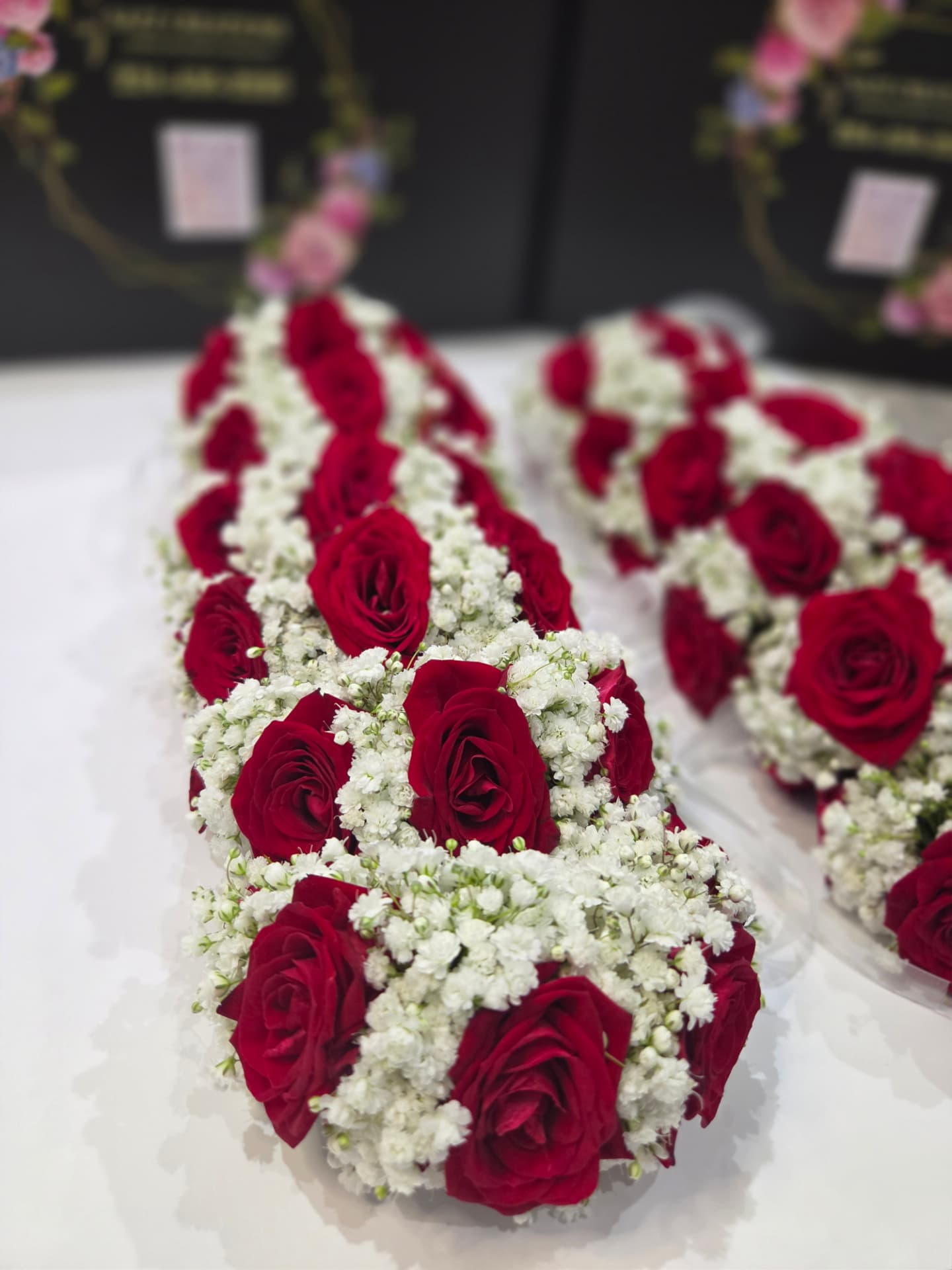 Red rose and baby's breath wedding garlands