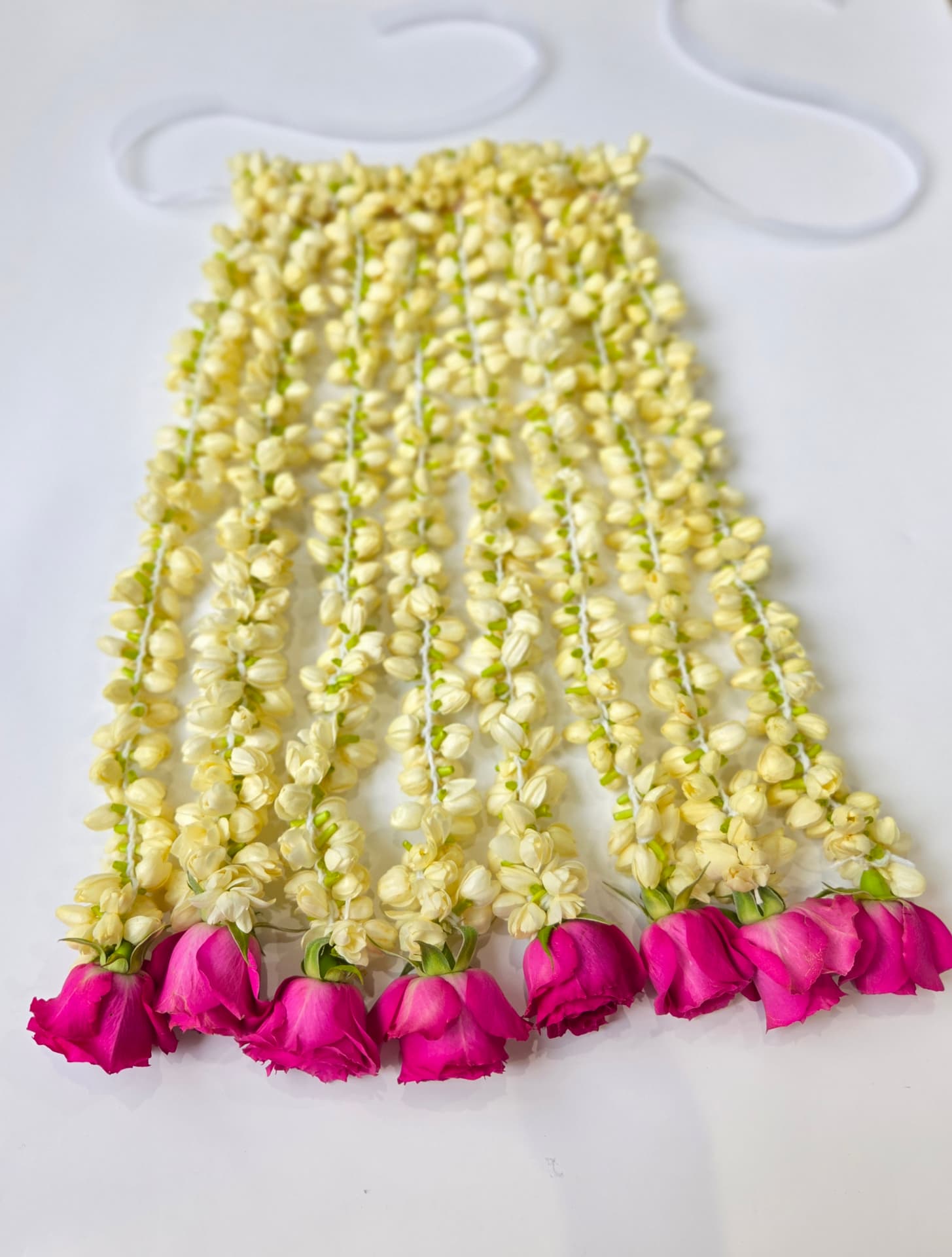 Fresh jasmine sehra with magenta rose blooms