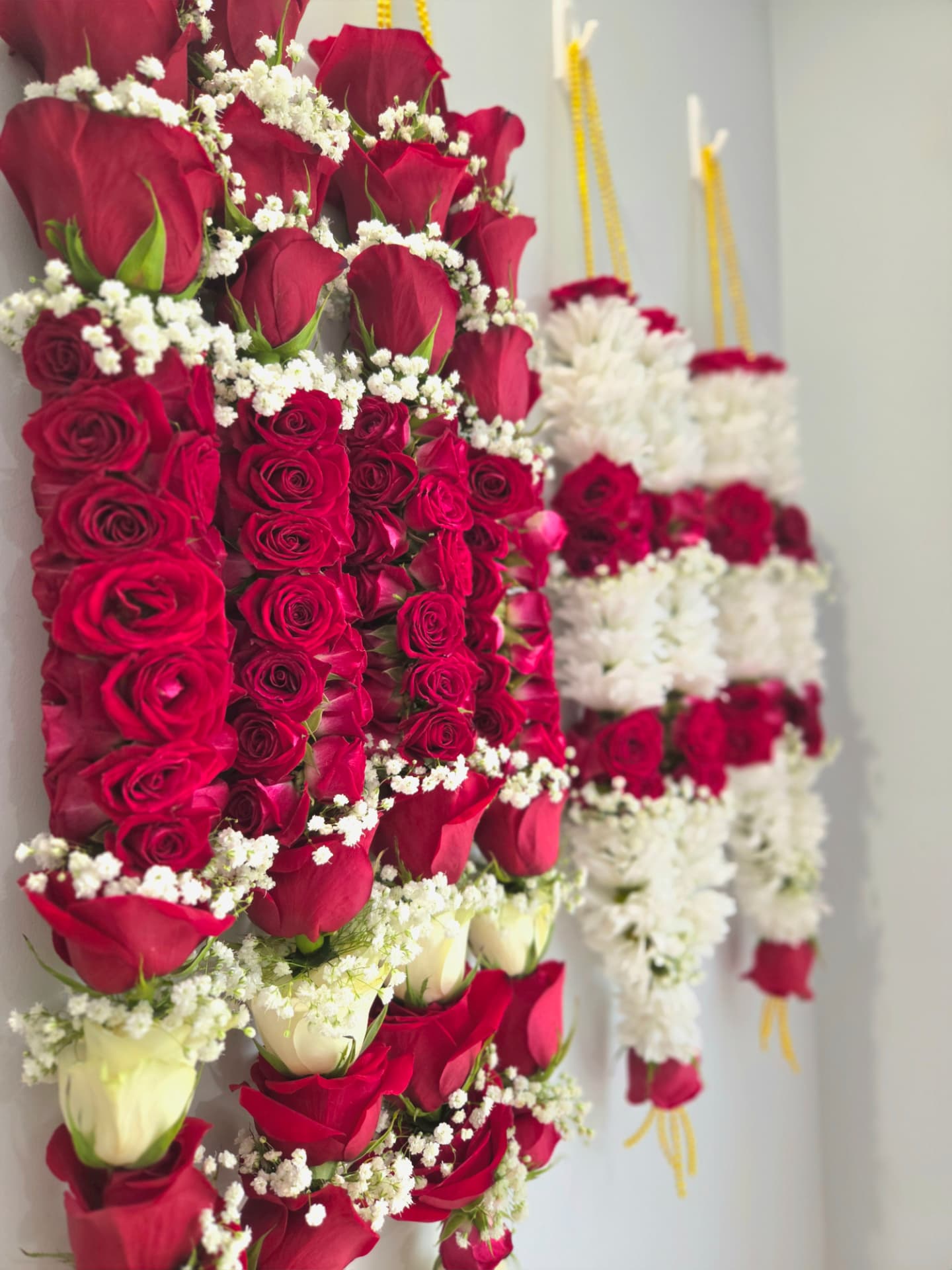 Collection of red rose wedding garlands with baby's breath