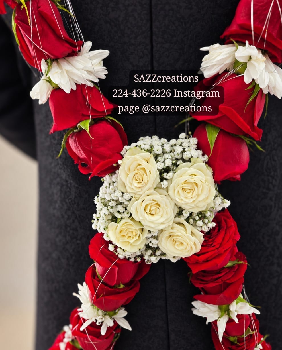 Close-up of baddi haar ivory rose and baby's breath centerpiece with red roses