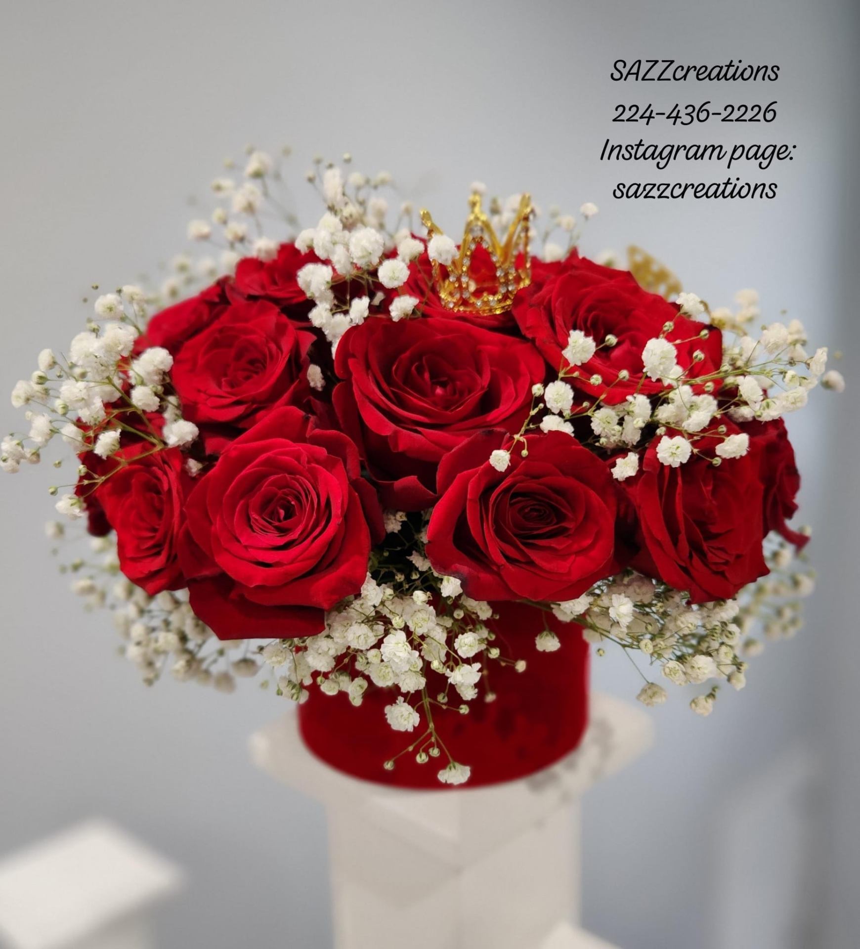 Red rose centerpiece with gold crown and baby's breath