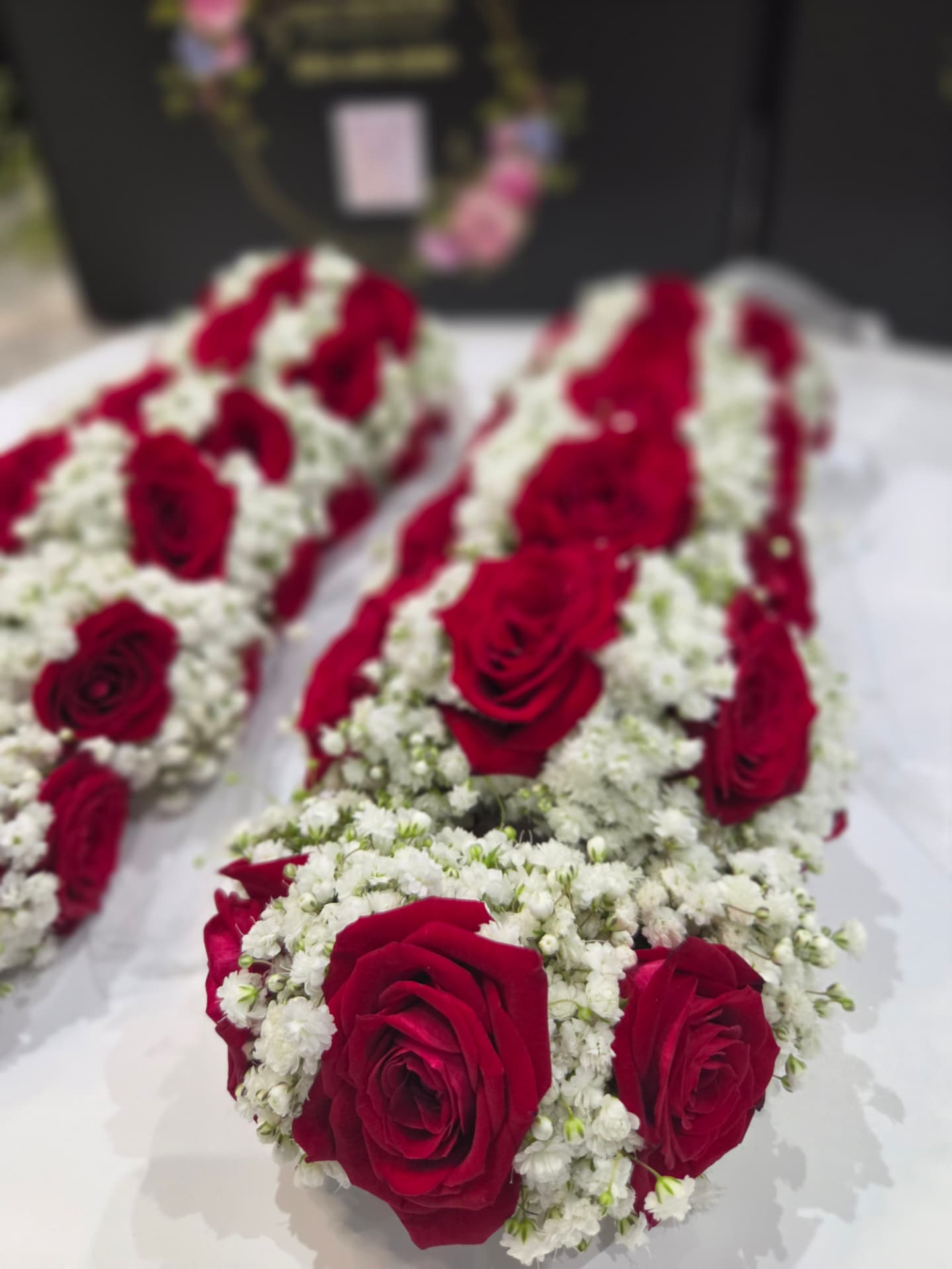 Detailed red rose and baby's breath wedding garland