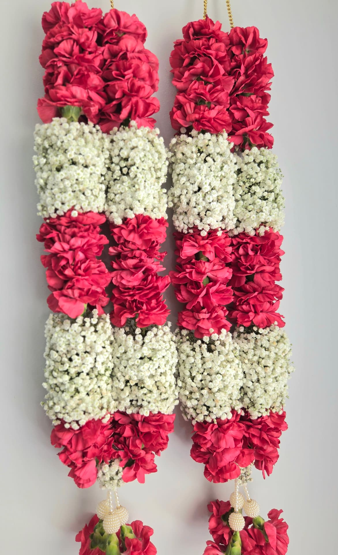 Pink carnation and baby's breath wedding garland pair with pearl tassels