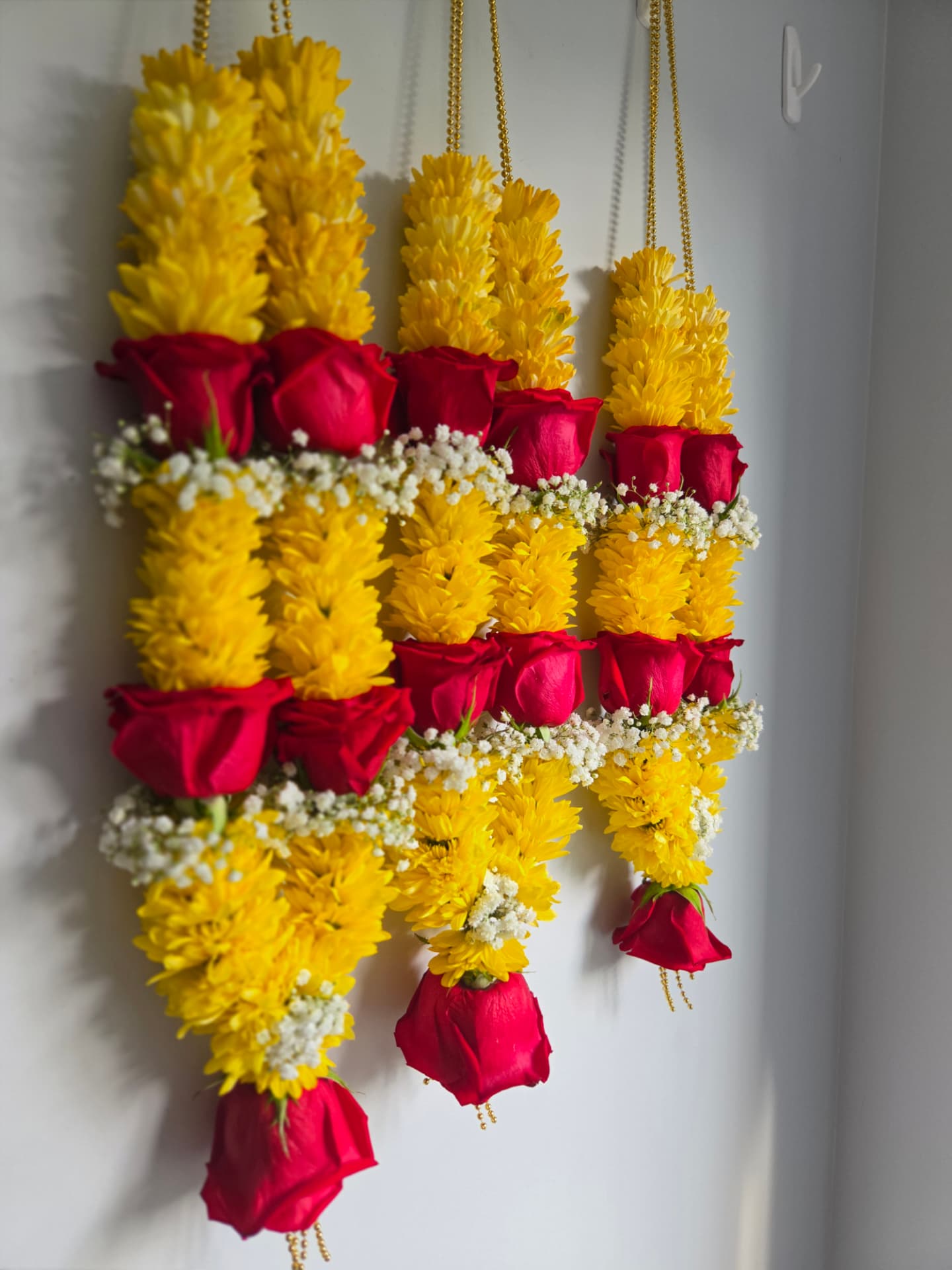 Yellow chrysanthemum and red rose wedding garlands